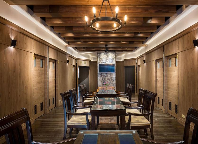 Jin Spa Resort Hotel in Jinshan District, wood-paneled private dining room with long table and chandelier