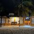 Hotel San Julio in Celestún with beachfront entrance, palm trees, and lit courtyard at night