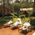 Pousada O Cantinho da Raposa in Monte Verde with guests lounging beside a small pool and garden