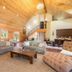 Franziska Haus in Dundee: airy lodge-style lounge with vaulted wood ceiling, sofas, and dining area