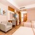 Venosa Beach Resort And Spa in Didim guest room with two beds, armchair, desk and TV