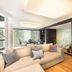 Living Hotel Prinzessin Elisabeth Munich suite with sofa, wood floors, and large windows