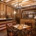 Rokeby Manor in Invergarry, rustic dining room with wooden beams, chandelier and bar