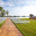 Outdoor lakeside wedding setup at Super 8 by Wyndham Riverside AL in Riverside with aisle and chairs