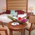 Oriental Crystal Hotel in Kajang guest room with king bed, wooden chairs, and a small table