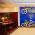 Golden Tulip Kumasi City lobby with yellow tandem bicycles mounted on a blue wall display in Kumasi