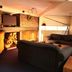 Tussock Grove Boutique Ohakune lounge with fireplace, leather sofas, bar counter and TV