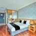 Quayside Hotel Malacca guest room with double bed, desk, TV and city-view window