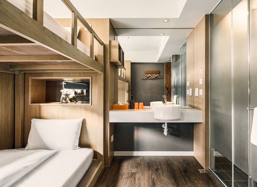 Orange Hotel - Ximen, Taipei bunk bed and sink vanity in compact modern guest room