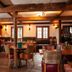 The Wiremill in Lingfield: rustic restaurant dining room with wooden beams, tables, and staircase