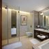 JW Marriott Hotel Bengaluru bathroom with soaking tub, double vanity and glass shower