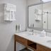 Hampton Inn Kansas City The Legends bathroom vanity with double sinks and large wall mirror