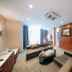 Petro Hotel Vung Tau suite living area with sofa, coffee table, and desk