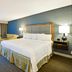 Hampton Inn Sarasota-I-75 Bee Ridge guest room with king bed, seating area and TV