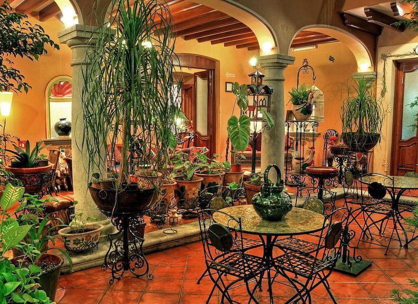 Hotel Boutique Parador San Miguel Oaxaca courtyard with arches, terracotta tiles and potted plants in Oaxaca