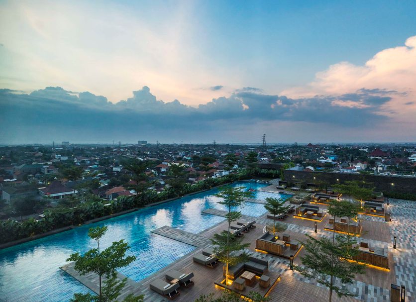Alila Solo in Surakarta City with rooftop infinity pool and city skyline at sunset