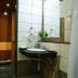 Fabhotel Prime Chennai Deluxe bathroom with sink, mirror, shower and open doorway in Chennai