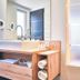 Hotel Eibl-Brunner 4-Sterne-Superior bathroom with double sinks and frosted glass shower in Frauenau