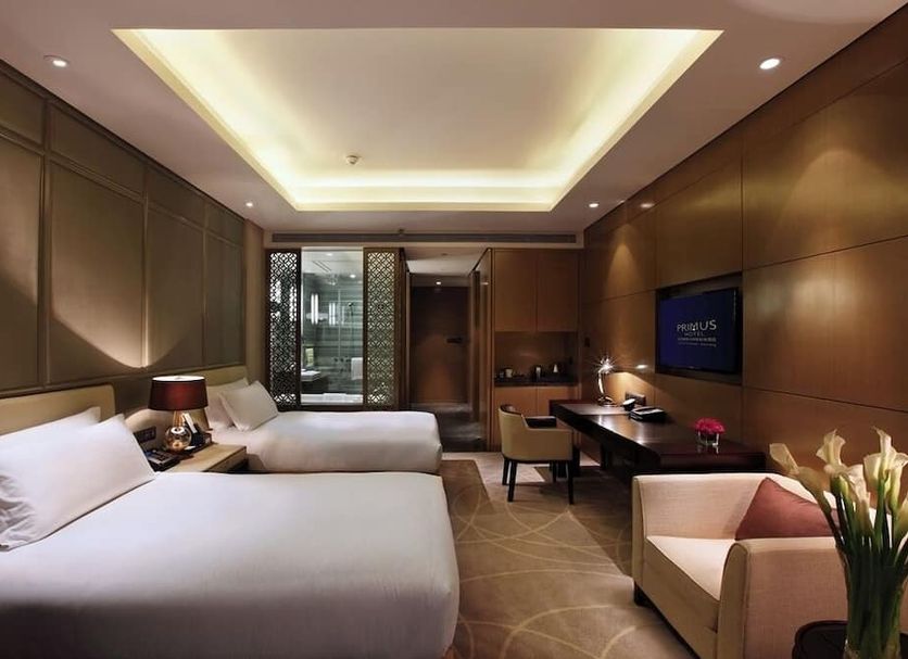 Primus Hotel Qipan Mountain Shenyang guest room with two beds, desk and city view