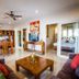Bali Lovina Beach Cottages in Buleleng living room with sofas, coffee table, dining area and kitchen