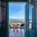 Kaliviani Traditional Hotel in Kissamos, balcony with table, chairs and sea view through open doors