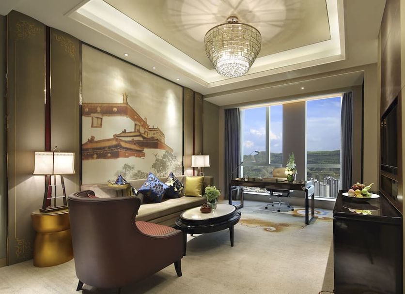 Wanda Vista Xining suite with city view, chandelier, seating area and large window in Xining