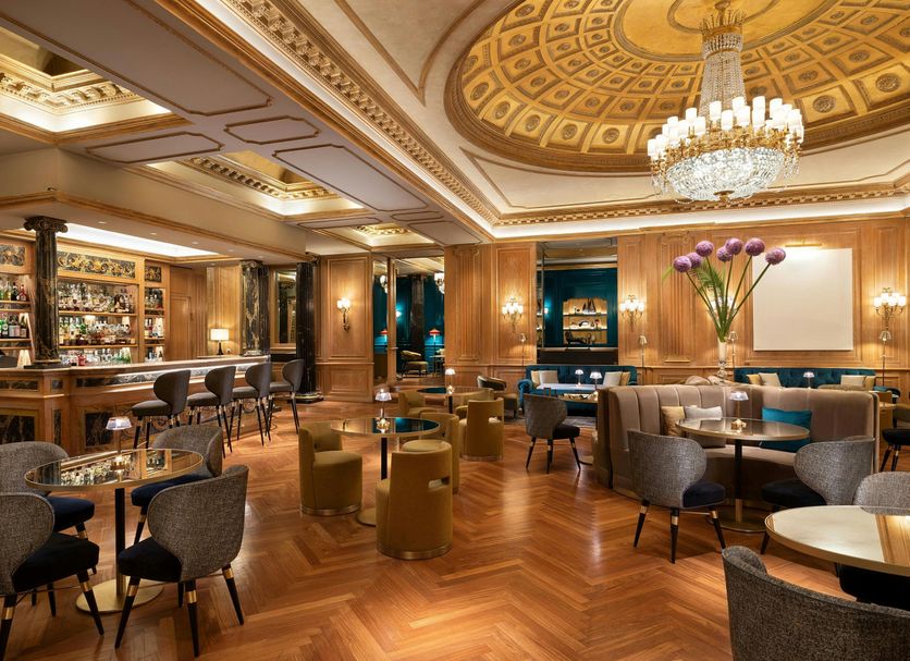 The Westin Palace, Milan lounge bar with chandeliers, wood floors, and seating in Milan