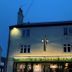 The Green Man in Rugby exterior at dusk with illuminated pub-style facade