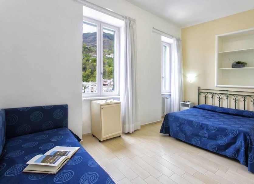 Terme Miramonte e Mare room in Casamicciola Terme with bed, sofa and mountain-view windows