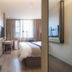 Motel168 Shanghai Qi Bao Inn room with bed, desk and window view in Shanghai