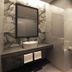 Kuala Lumpur International Hotel bathroom with vessel sink, mirror, glass shower, and toilet in Kuala Lumpur