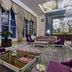 Rixos President Astana lobby with purple velvet chairs, glass tables, ornate chandelier and tall windows