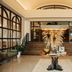 Emeline Charleston lobby with grand staircase and decorative pampas grass arrangement