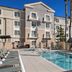 TownePlace Suites by Marriott Ontario Airport in Rancho Cucamonga: outdoor pool with lounge chairs and palm trees