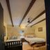 Dona Elvira Boutique Hotel Santo Domingo guest room with two beds and exposed-beam ceiling