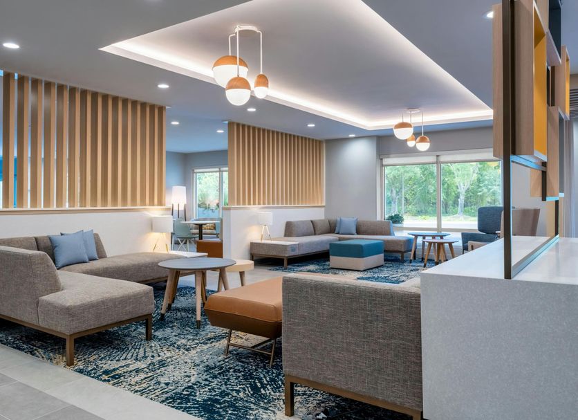 TownePlace Suites by Marriott Brunswick lobby with gray seating, pendant lights and large windows