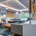 TownePlace Suites by Marriott Brunswick lobby with gray seating, pendant lights and large windows