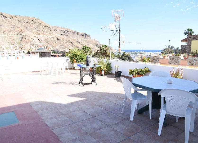 Pension Eva, Puerto de Mogan terrace with tables, chairs and distant sea view
