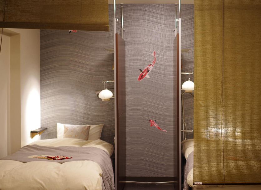 Oakhostel Zen Tokyo bedroom with two single beds and a patterned wall divider