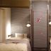 Oakhostel Zen Tokyo bedroom with two single beds and a patterned wall divider