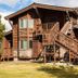 Timbers at Island Park exterior with wood siding and outdoor staircase in Island Park