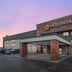 La Quinta Inn & Suites by Wyndham Nashville Airport exterior with covered entrance at dusk