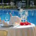 Hotel Ristorante Dragonara in San Giovanni Teatino: poolside dining table beside an outdoor swimming pool