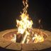 White Mountain Motel And Cottages in Lincoln: outdoor fire pit with burning logs at night