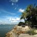 Garden Sea View Resort Pattaya with palm-lined seaside shore and rocky waterfront under blue sky