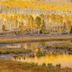 High Desert Inn in Salina with golden autumn trees reflected in a peaceful pond