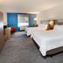 Holiday Inn Express & Suites Dumas by IHG guest room with two queen beds and blue accent wall