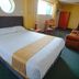 Hotel La Joya Huaraz room with double bed, seating area and round window