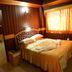 Hotel City Tower Coimbatore room with double bed, wood-paneled walls, and large window