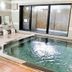 Hotel Route-Inn Aomori Ekimae indoor bath with tiled soaking pool and shower stations in Aomori